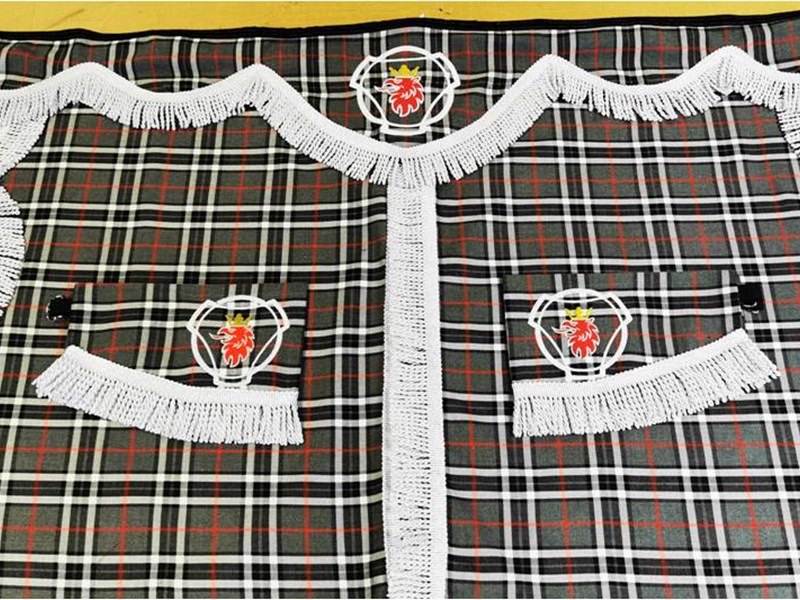 finished pair of tartan patterned curtains with embroidery made by caroline