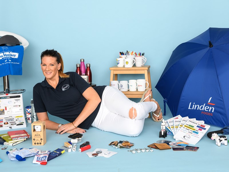 Woman reclining on floor surrounded by various stationary products