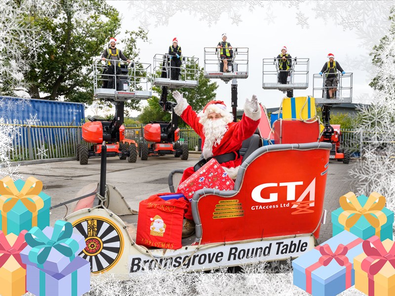 Santa sitting in a GTA branded sleigh with 5 people behind in cherry pickers wearing santa hats and high vis jackets